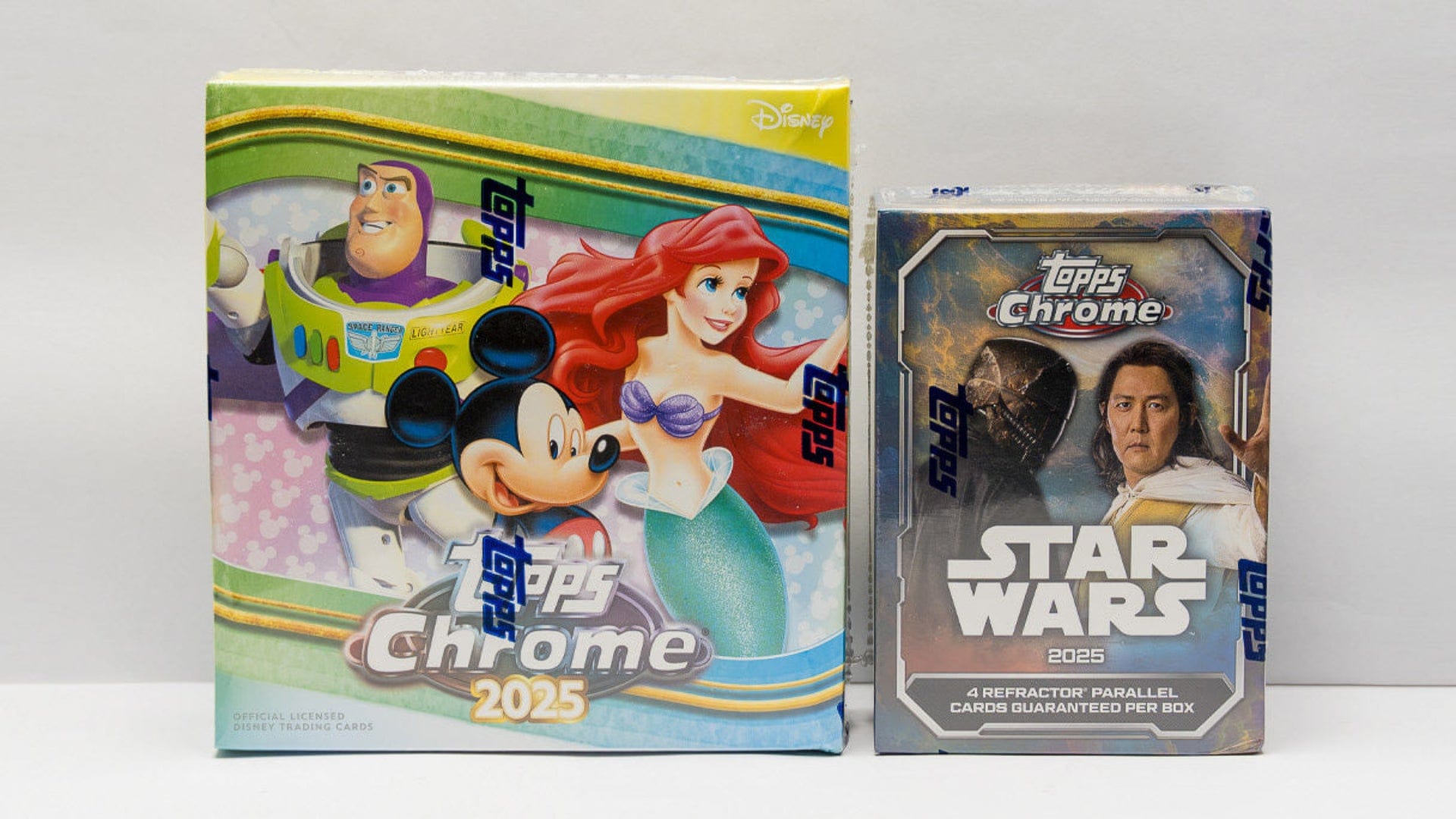 Two trading card boxes from Disney and Star Wars on a white background