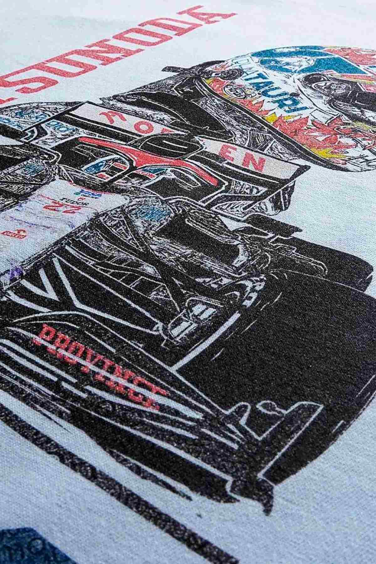 Utmost Province Yuki Tsunoda F1 Hoodie laid flat on a table, highlighting the graphic design on the back of the unisex fleece hoodie.
